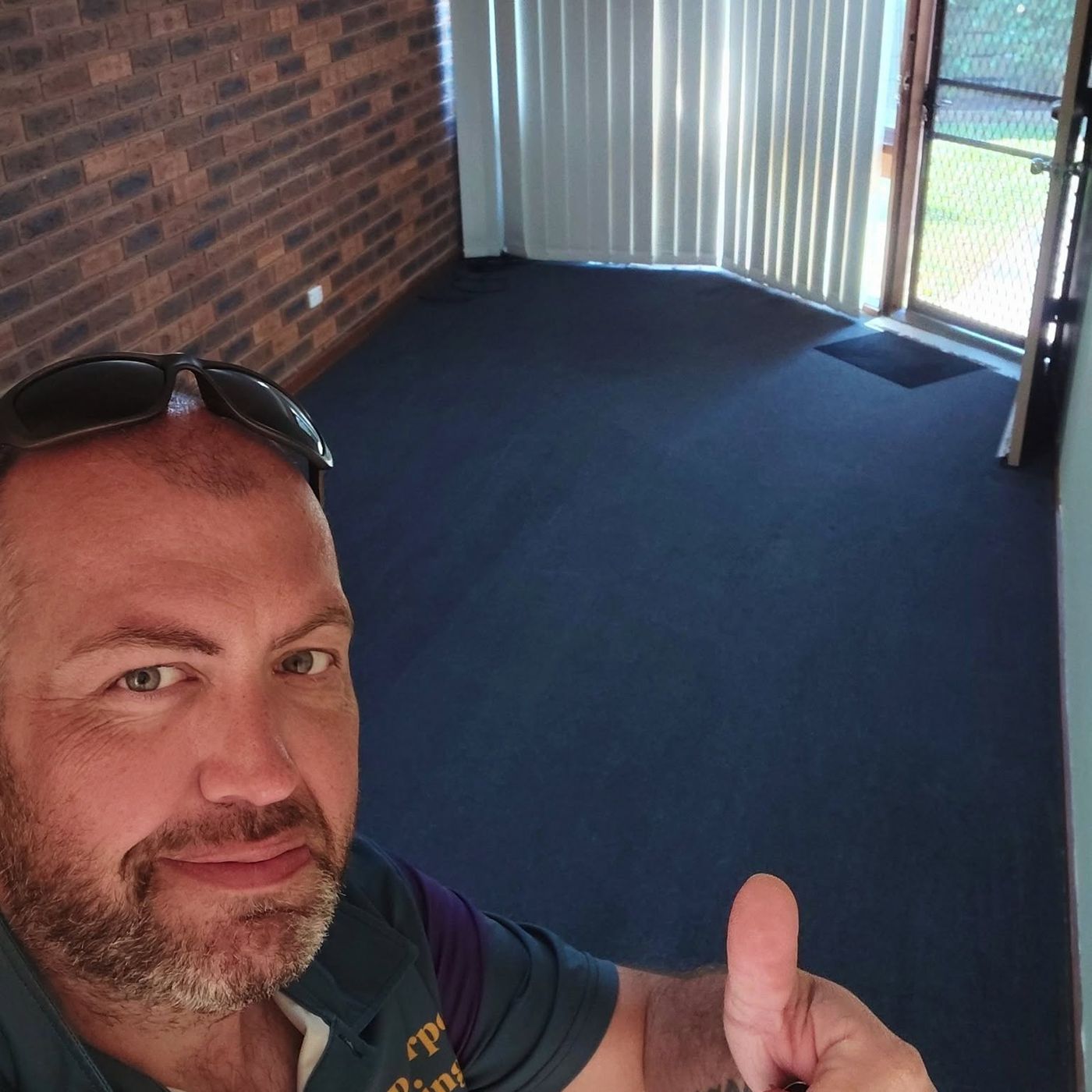 The RGP Carpet Cleaning operator giving a thumbs up in a freshly cleaned room
