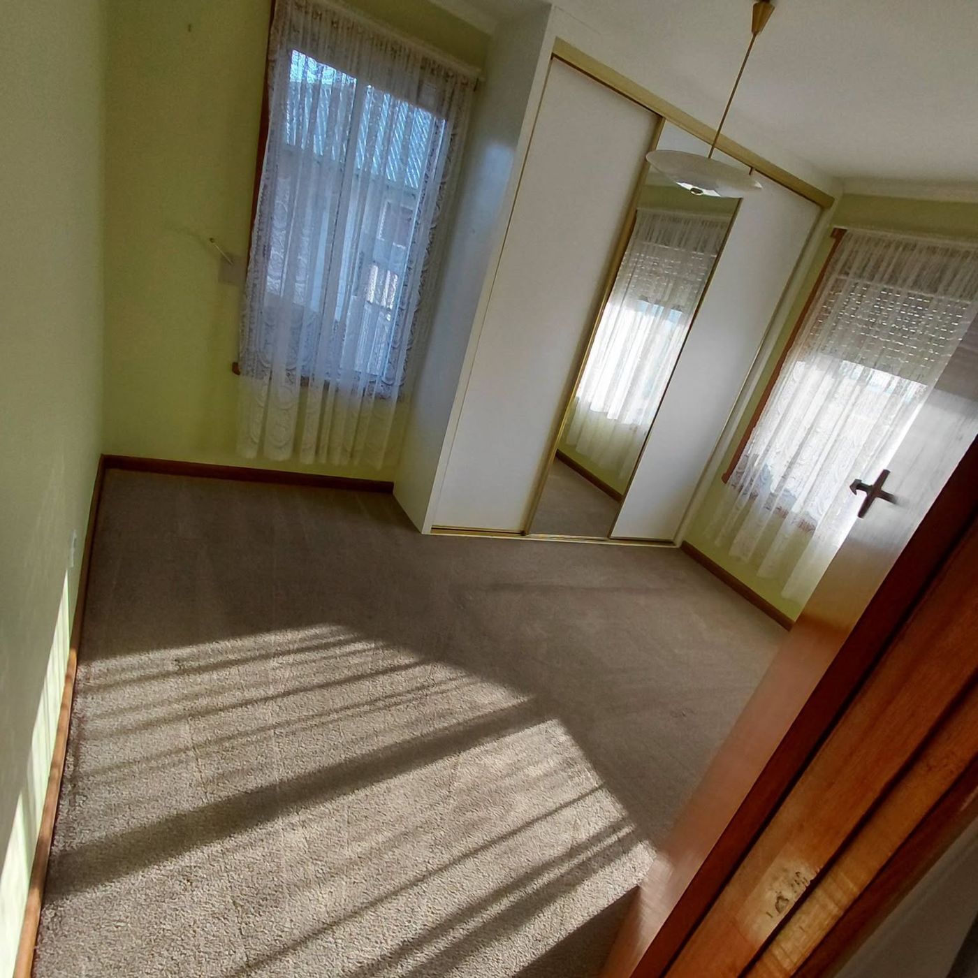 Sunlight across a freshly cleaned bedroom carpet